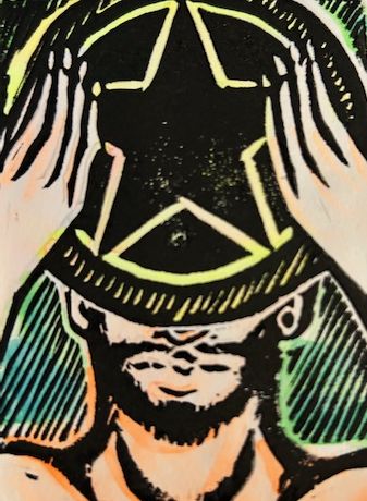 A man holding up a large coin that obscures the top half of his face.